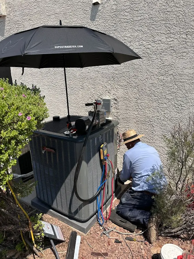HVAC technician performing outdoor AC maintenance in Flower Mound