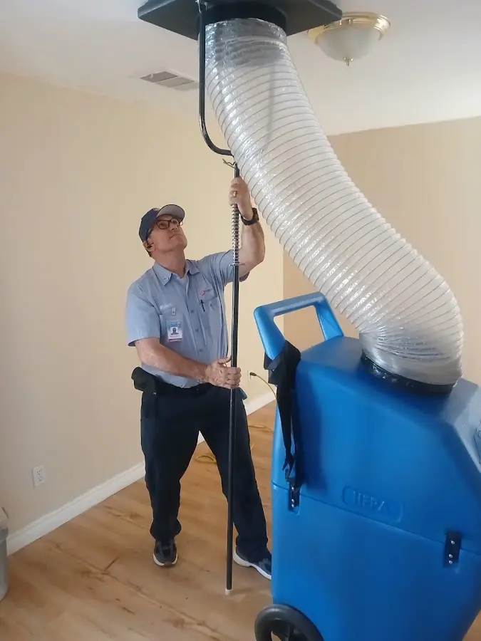 Furnace Tune-Up technician using HEPA equipment in Flower Mound